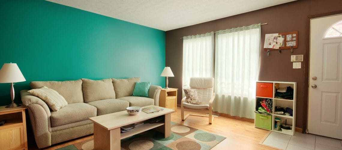 Laminate flooring installed in a brightly colored living room.